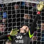 Kiper James Trafford menepis satu serangan Liverpool