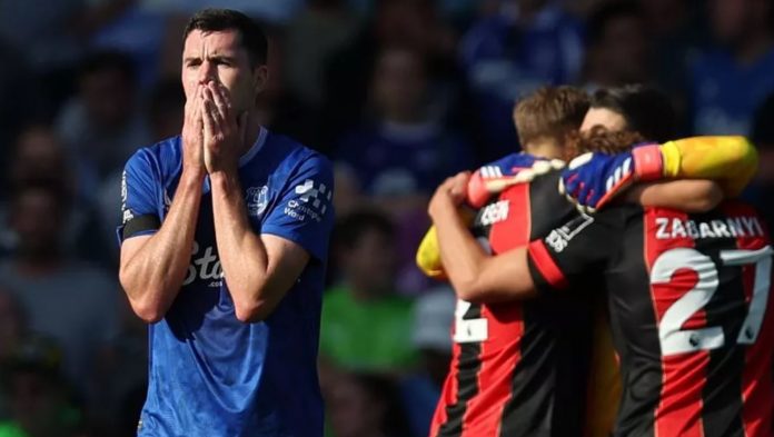 Everton 2-3 Bournemouth: Luis Sinisterra Cetak Gol Kemenangan di Menit ke-96, Cherries Balikkan Keadaan dan Tambah Penderitaan Toffees Awal musim yang suram bagi Everton berlanjut setelah Bournemouth bangkit dari ketertinggalan dua gol untuk meraih kemenangan luar biasa di Goodison Park. Tim asuhan Sean Dyche tampak melaju menuju kemenangan pertama mereka di Premier League musim ini setelah gol dari Michael Keane dan Dominic Calvert-Lewin. Namun, dalam waktu lima menit yang menegangkan, Cherries berhasil menyamakan kedudukan. Antoine Semenyo mencetak gol dengan penyelesaian tenang di tiang jauh untuk memperkecil ketertinggalan sebelum kapten tim tamu, Lewis Cook, menyundul bola melewati Jordan Pickford. Masih ada waktu bagi Luis Sinisterra untuk mencetak gol kemenangan yang sensasional, menambah penderitaan bagi Dyche dan para pemainnya saat rekor tanpa kemenangan mereka berlanjut.