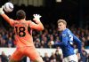 Jarrad Branthwaite menyundul bola ke gawang Ortega Moreno