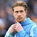 Kevin de Bruyne mengenakan jaket Manchester City