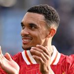 Trent Alexander-Arnold tersenyum usai mencetak gol