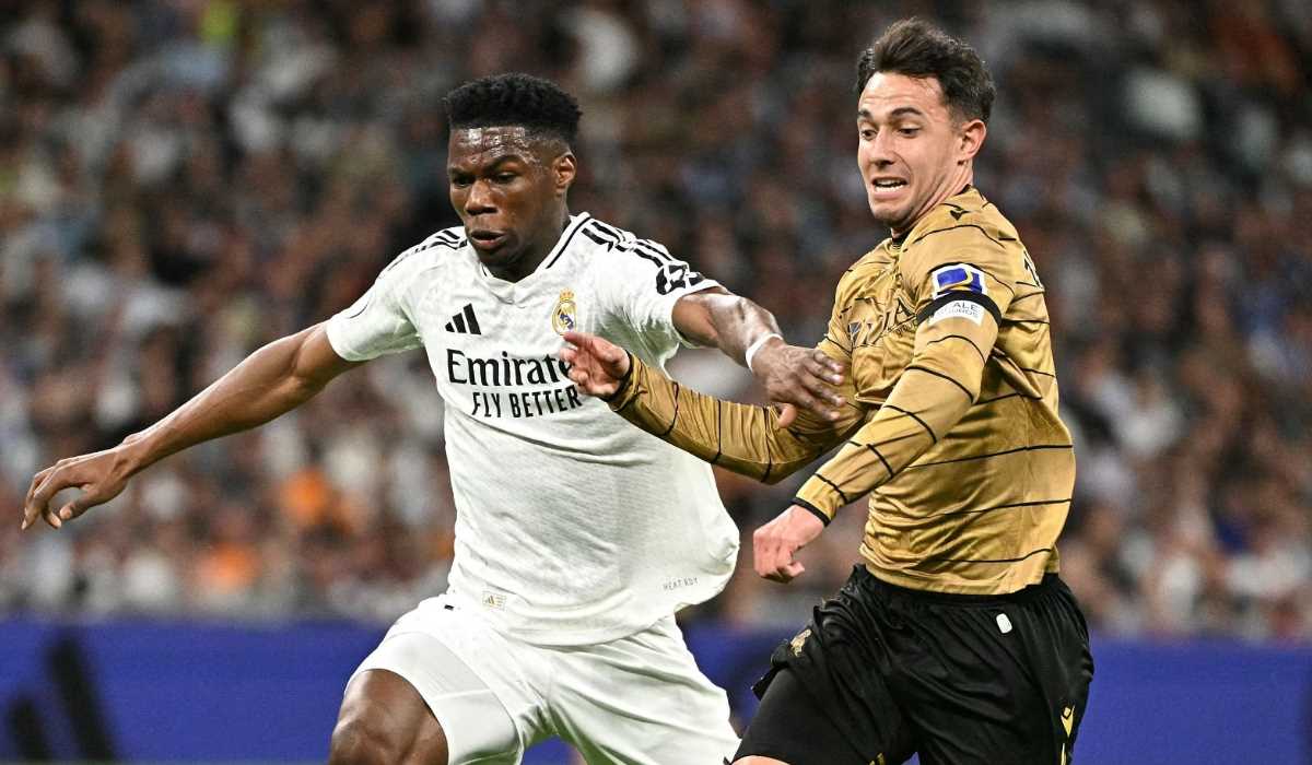 Martin Zubimendi berebut bola dengan Aurelien Tchouameni