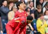 Jarrel Quansaha menunduk dengan bersandar lutut di samping Wataru Endo