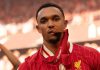 Trent Alexander-Arnold memamerkan medali Premier League yang dimenangkannya